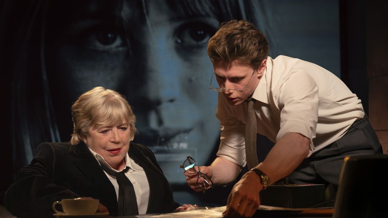 a mana nd woman looking at papers